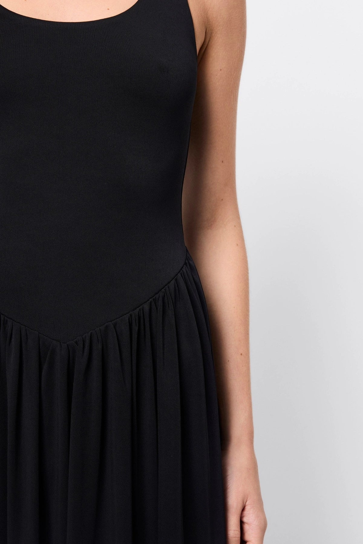 Haven Midi Dress Black by Mossman, a sleeveless sculpted midi with dipped waist and bubble hem. Perfect for day to night wear.