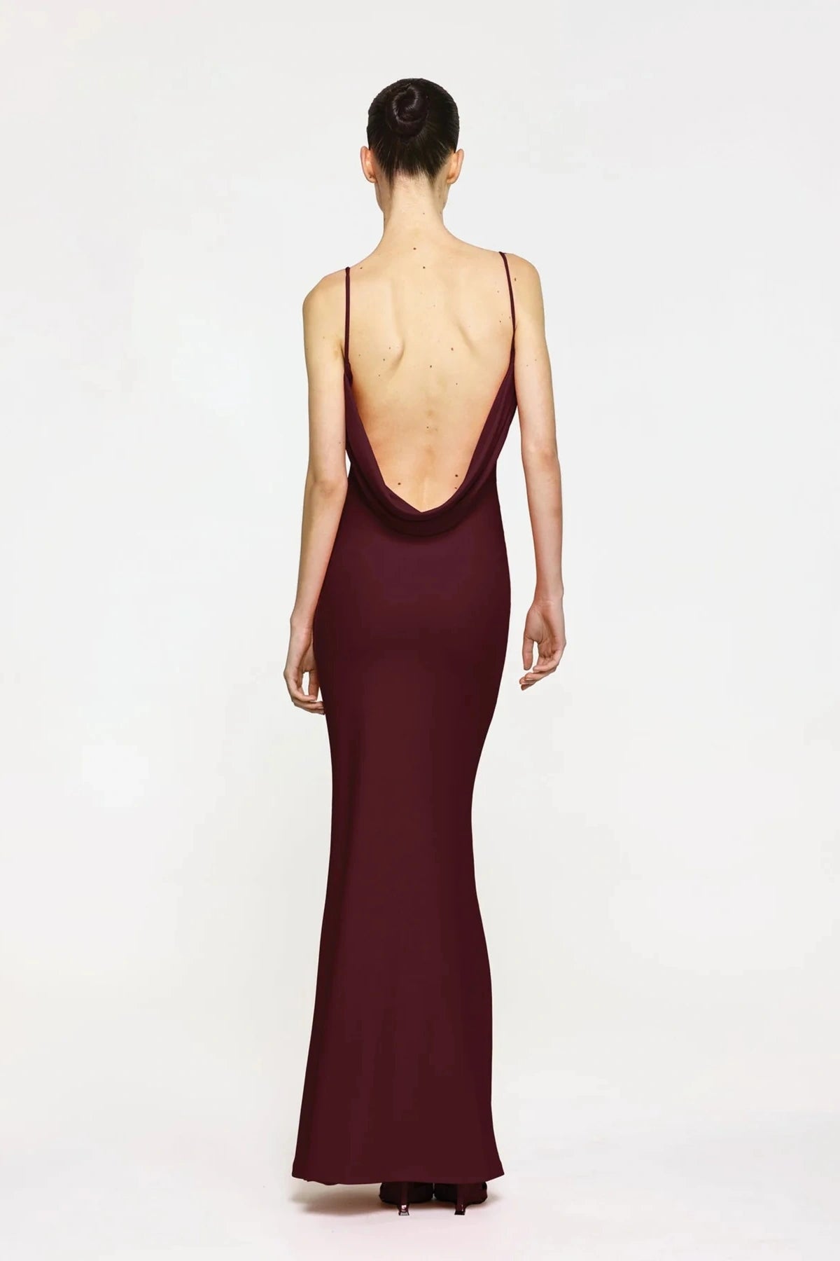Havilland Gown in Wine by Effie Kats, elegant straight-neck silhouette with delicately draped low back, crafted in soft stretch crepe for a refined evening look.