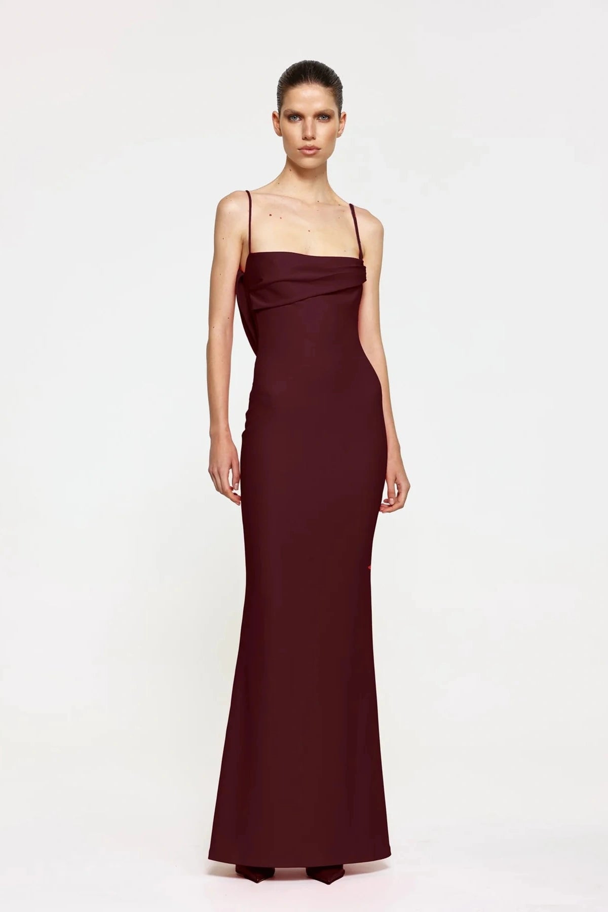 Havilland Gown in Wine by Effie Kats, elegant straight-neck silhouette with delicately draped low back, crafted in soft stretch crepe for a refined evening look.