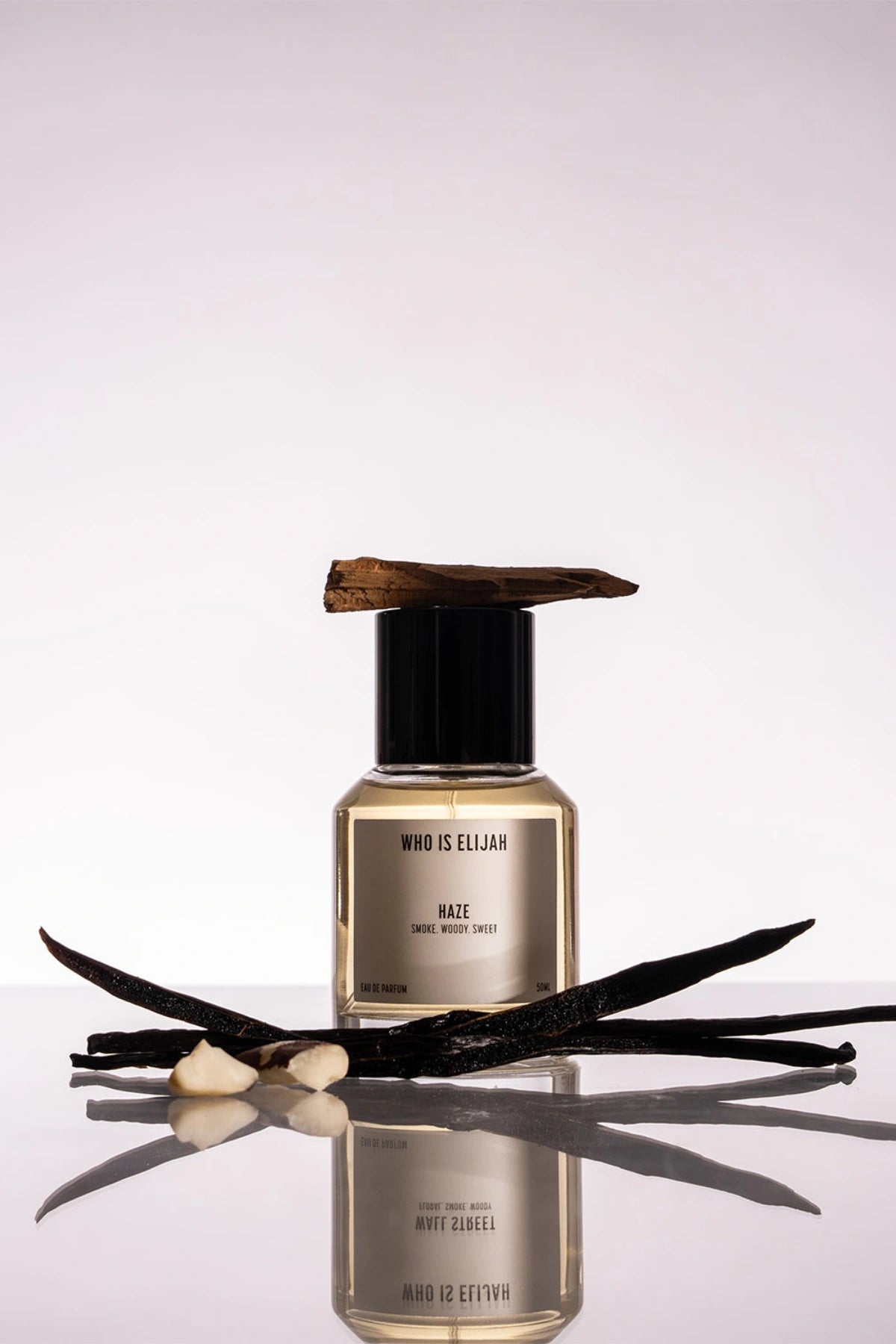 Haze by Who Is Elijah, a unisex scent with pink pepper, orange blossom, clove, chestnut, cedarwood, vanilla, and warm woods.