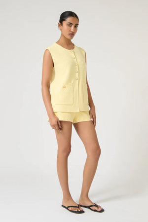 Helena Gilet by Onte, butter cotton crochet knit vest with enamel gold buttons and a relaxed sleeveless fit, perfect for layering.