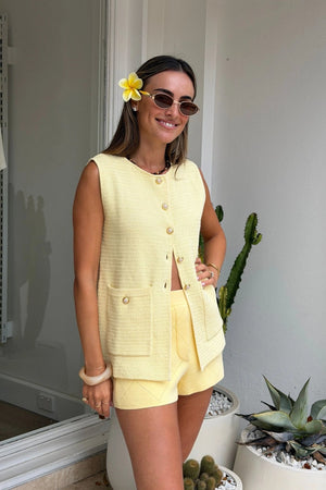 Helena Gilet by Onte, butter cotton crochet knit vest with enamel gold buttons and a relaxed sleeveless fit, perfect for layering.