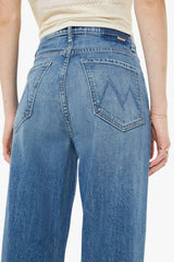 High Waisted Tunnel Vision Sneak Girls Just Want To Have Sun by MOTHER - wide leg jeans in mid blue wash, designed for a high rise fit.