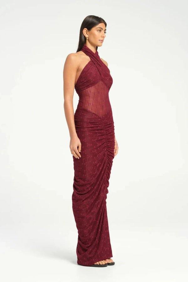 Hudson Lace Maxi Dress Sangria by Benni, sensual stretch lace with twist halter neckline, ruched seams, sheer waist panel for a bold evening look.