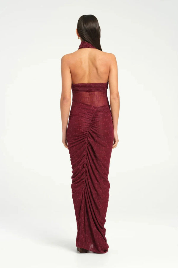 Hudson Lace Maxi Dress Sangria by Benni, sensual stretch lace with twist halter neckline, ruched seams, sheer waist panel for a bold evening look.