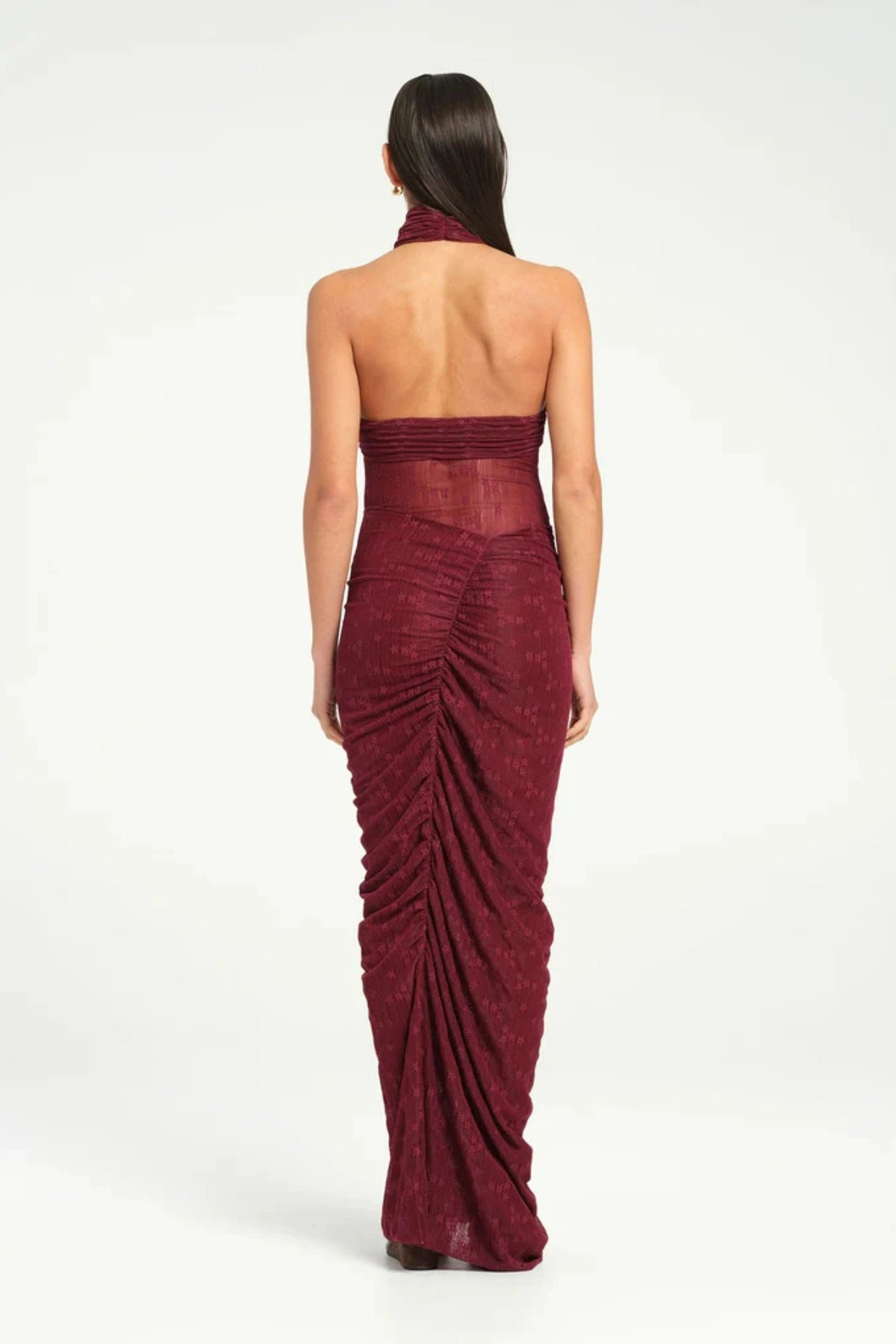 Hudson Lace Maxi Dress Sangria by Benni, sensual stretch lace with twist halter neckline, ruched seams, sheer waist panel for a bold evening look.