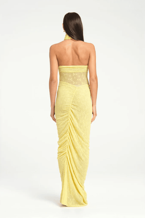 Hudson Lace Maxi Dress Butter by Benni, elegant stretch lace dress with twist halter neck, ruched seams, and sheer waist panel for a bold evening look.