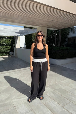 Jade Pant Black by Sneaky Link, relaxed, drapey pants in a luxe poly-viscose blend with elastic waistband, contrast panels, and adjustable drawcord. Designed oversized; size down if between sizes.