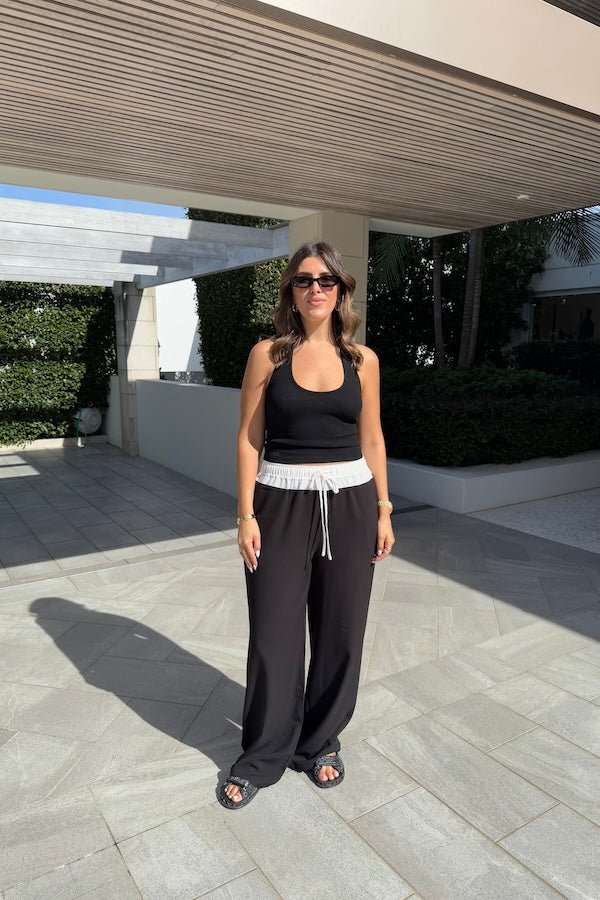 Jade Pant Black by Sneaky Link, relaxed, drapey pants in a luxe poly-viscose blend with elastic waistband, contrast panels, and adjustable drawcord. Designed oversized; size down if between sizes.