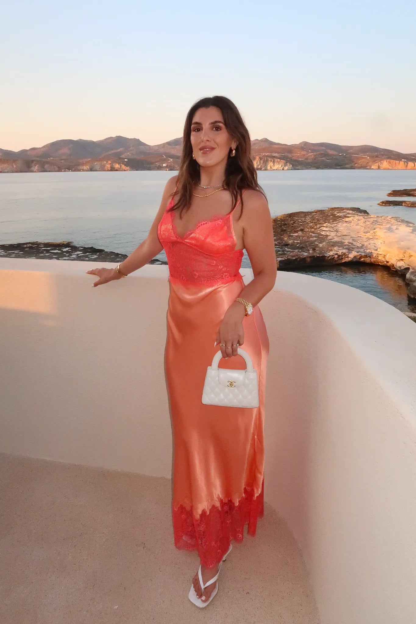 Lilah Maxi Dress in Orange by Sneaky Link, silk-lace maxi in vibrant tangerine with fluid drape and lace panels. Perfect for event dressing.
