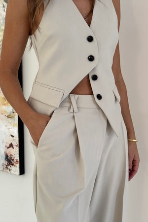 Marlie Tailored Vest Stone by Sneaky Link – Sharp, structured vest in a premium poly-viscose blend with a button front. Perfect paired with Marlie Pant. Dry clean only.