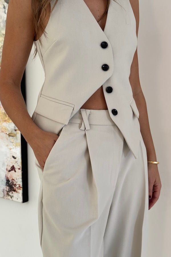 Marlie Tailored Vest Stone by Sneaky Link – Sharp, structured vest in a premium poly-viscose blend with a button front. Perfect paired with Marlie Pant. Dry clean only.