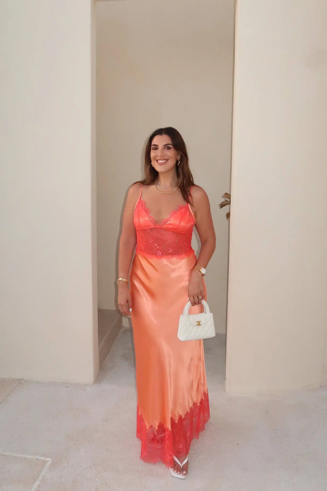Lilah Maxi Dress in Orange by Sneaky Link, silk-lace maxi in vibrant tangerine with fluid drape and lace panels. Perfect for event dressing.
