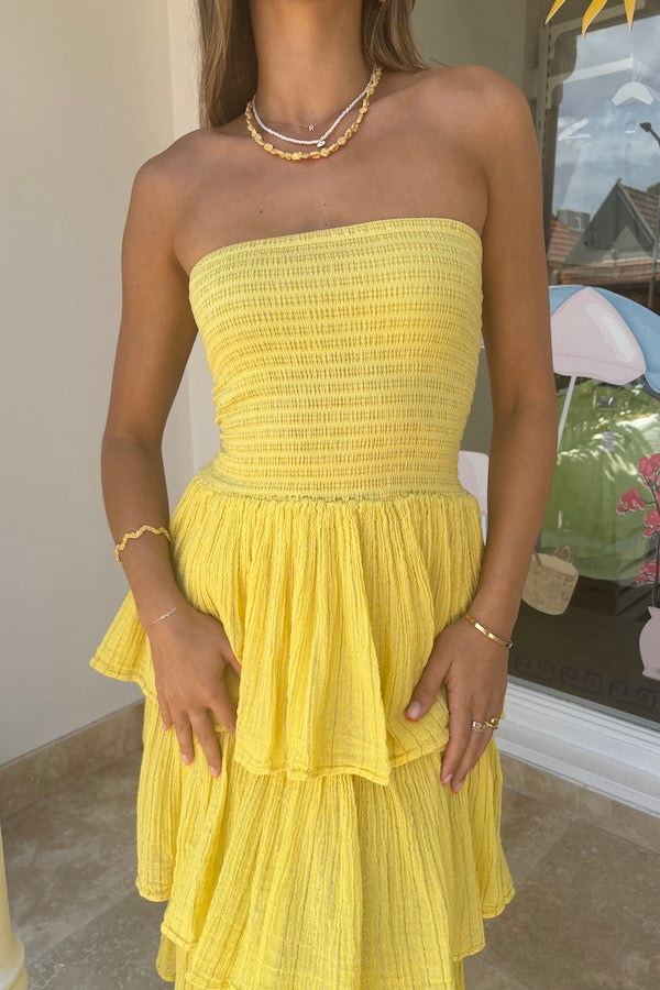 Tiered Maxi Dress Lemon/Gold by D'Artemide – Cotton strapless dress with ruffle layers and bandeau top for a flattering fit.