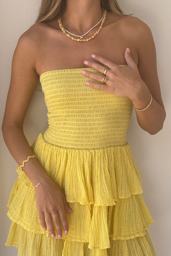 Tiered Maxi Dress Lemon/Gold by D'Artemide – Cotton strapless dress with ruffle layers and bandeau top for a flattering fit.