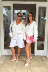 Jaz Oversized V Neck Knit Sweater in White with a deep V neckline and relaxed slouchy fit, creating a soft draped silhouette with a clean, oversized finish.