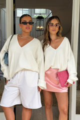 Jaz Oversized V Neck Knit Sweater in White with a deep V neckline and relaxed slouchy fit, creating a soft draped silhouette with a clean, oversized finish.