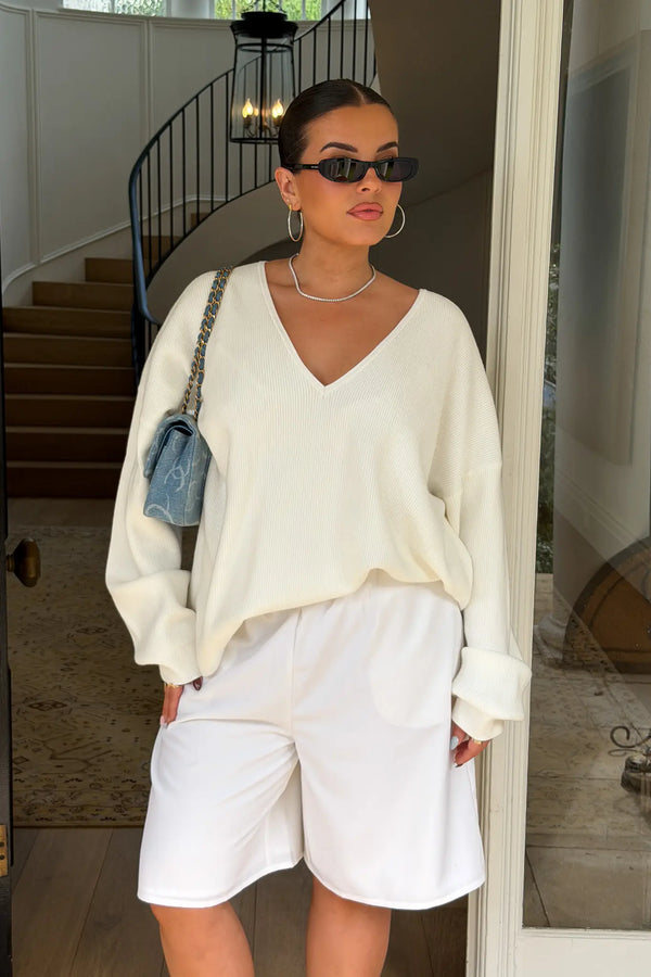Jaz Oversized V Neck Knit Sweater in White with a deep V neckline and relaxed slouchy fit, creating a soft draped silhouette with a clean, oversized finish.