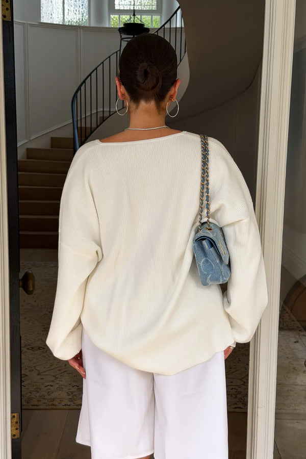 Jaz Oversized V Neck Knit Sweater in White with a deep V neckline and relaxed slouchy fit, creating a soft draped silhouette with a clean, oversized finish.