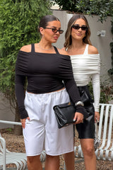 Jaz Layered Long Sleeve Top in Black with a soft off shoulder layered neckline and fitted long sleeves, creating a smooth, sculpted silhouette with a clean, modern edge.