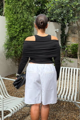Jaz Layered Long Sleeve Top in Black with a soft off shoulder layered neckline and fitted long sleeves, creating a smooth, sculpted silhouette with a clean, modern edge.
