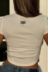 Baby Tee White by Sneaky Link – Cropped viscose-spandex ribbed tee with iconic embroidered snake at the back neck, a versatile staple perfect for pairing with cargo or Aspen pants for a fresh, effortless look.