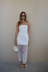 Jordi Lace Skirt White by Sneaky Link – Elegant maxi skirt with scalloped hem and clean waist binding, perfect for chic day-to-night styling.
