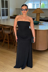 Jaz Strapless Split Maxi Dress in Black with a strapless neckline, sculpted waist, and side split creating a smooth, body hugging silhouette with a clean, contoured finish.