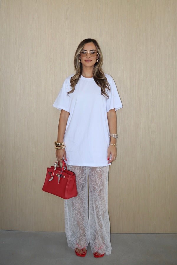 Jordi Lace Pant White by Sneaky Link, sheer lace pants with scalloped hem and elastic waist. Perfect for trendy layering or viral casual elegance.