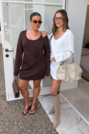 Jaz Long Sleeve Knot Mini Dress in White with a soft front knot, sculpted waist, and gentle ruching that creates a smooth, body hugging silhouette with a clean, elevated finish.