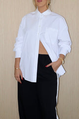 Boston Shirt White by Sneaky Link – Crisp oversized cotton poplin with button front and signature snake embroidery. Perfect for viral classic and casual-chic looks.