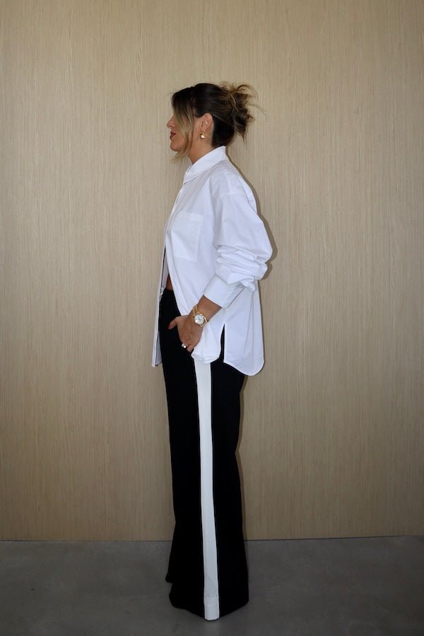 Boston Shirt White by Sneaky Link – Crisp oversized cotton poplin with button front and signature snake embroidery. Perfect for viral classic and casual-chic looks.