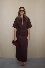 Lefka Midi Dress Chocolate by Sneaky Link – A trendy, breathable linen midi with flattering skirt tucks and button-front neckline, perfect for sunny lunches and relaxed summer days.