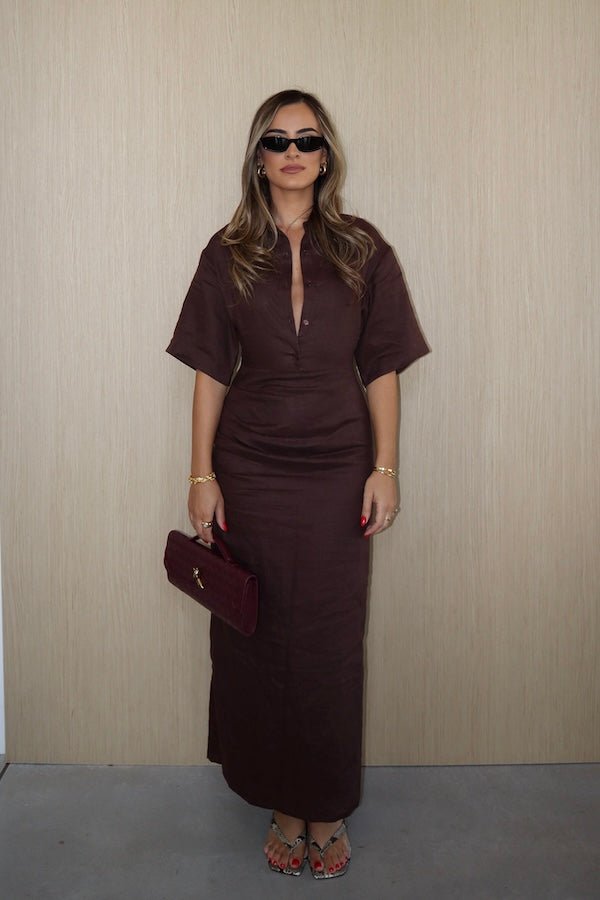 Lefka Midi Dress Chocolate by Sneaky Link – A trendy, breathable linen midi with flattering skirt tucks and button-front neckline, perfect for sunny lunches and relaxed summer days.