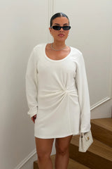 Jaz Long Sleeve Knot Mini Dress in White with a soft front knot, sculpted waist, and gentle ruching that creates a smooth, body hugging silhouette with a clean, elevated finish.