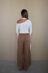 Issy Long Sleeve Top White by Sneaky Link – Soft modal-spandex with an off-shoulder neckline and built-in halter for support. Delicate fabric; handle with care. Cold hand wash.