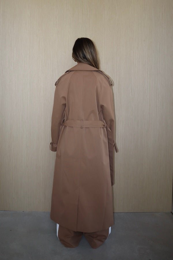 Trench Coat Tan by Sneaky Link – A timeless oversized coat in rich tan polyester, featuring classic details and subtle snake embroidery. Perfect for stylish transitional days.