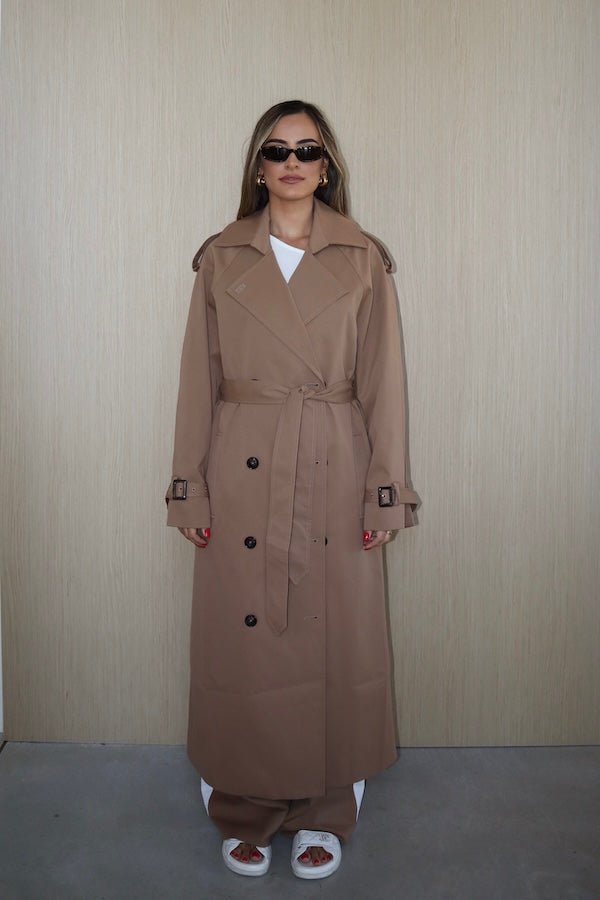 Trench Coat Tan by Sneaky Link – A timeless oversized coat in rich tan polyester, featuring classic details and subtle snake embroidery. Perfect for stylish transitional days.