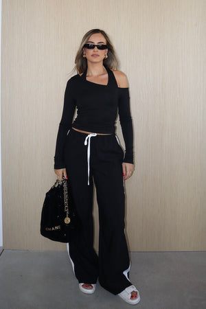 Issy Long Sleeve Top Black by Sneaky Link – Luxuriously soft modal-spandex with an off-shoulder neckline and built-in halter for support. Delicate fabric; handle gently. Cold hand wash.