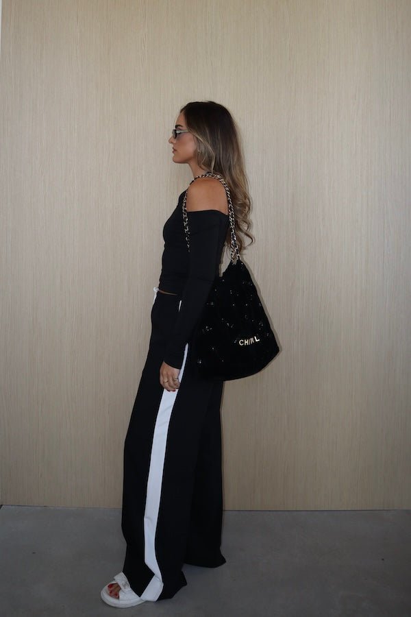 Sneaky Mini Skirt Black by Sneaky Link – A-line high-waisted mini with boned waist and flap pockets, perfect for day-to-night styling.