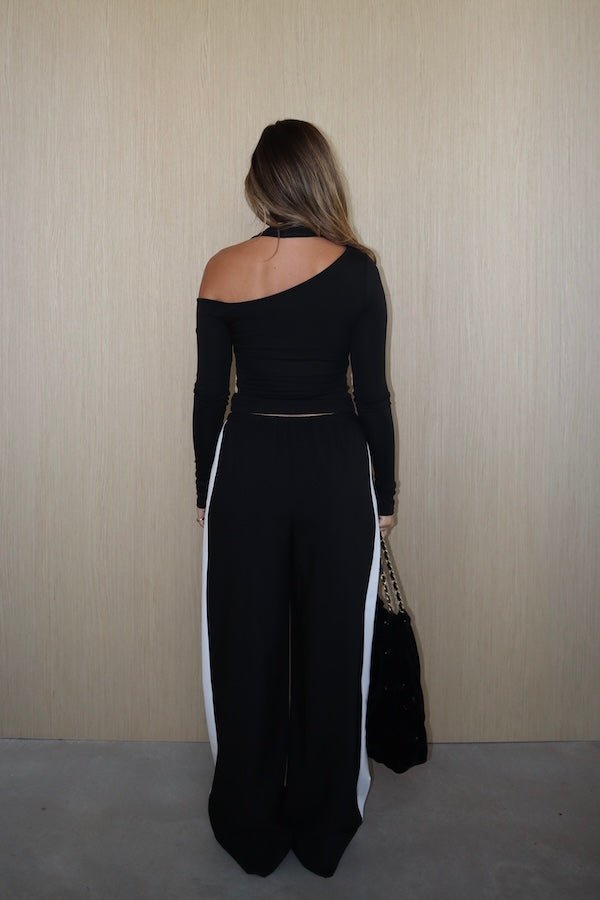 Sneaky Mini Skirt Black by Sneaky Link – A-line high-waisted mini with boned waist and flap pockets, perfect for day-to-night styling.