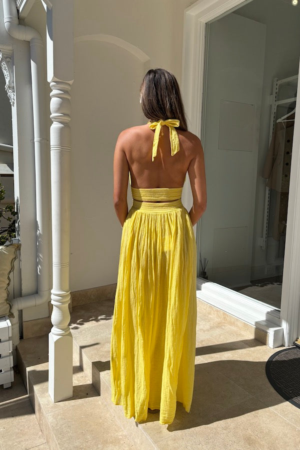Artemis Dress Lemon by D'Artemide – Cotton halterneck dress with cutout detailing and front split for a bold, stylish look.