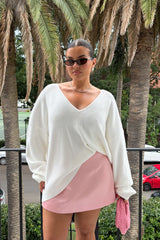 Jaz Oversized V Neck Knit Sweater in White with a deep V neckline and relaxed slouchy fit, creating a soft draped silhouette with a clean, oversized finish.