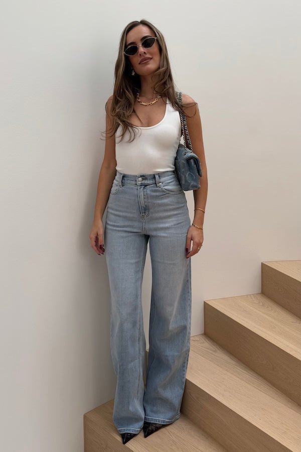 Celine High Rise Stretch Jean Light Blue by Sneaky Link, these flattering jeans feature a subtle flare and a premium stretch cotton blend for comfort and shape retention. Perfect for day to night wear.