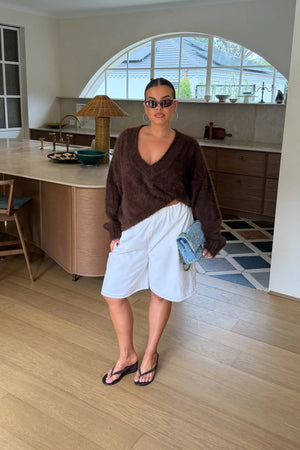 Jaz Fluffy V Neck Knit in Chocolate with a soft fluffy texture, relaxed fit, and deep V neckline creating a cosy, draped silhouette with a warm, elevated feel.