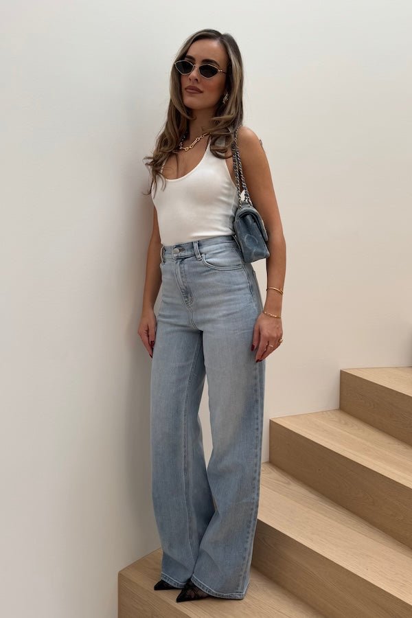 Celine High Rise Stretch Jean Light Blue by Sneaky Link, these flattering jeans feature a subtle flare and a premium stretch cotton blend for comfort and shape retention. Perfect for day to night wear.