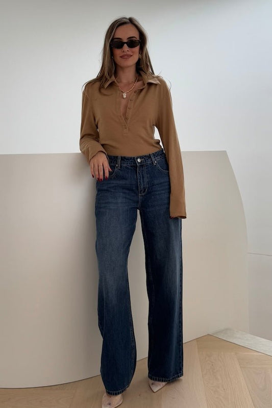 Elisha Baggy Jean Indigo by Sneaky Link, relaxed mid-rise baggy jeans in 100% cotton with branded details. Runs big; size down if unsure.