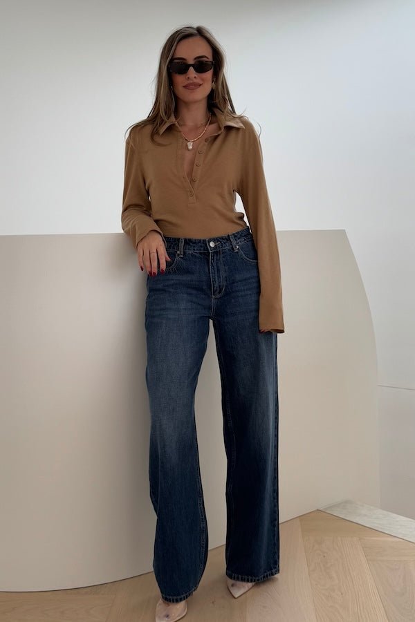 Elisha Baggy Jean Indigo by Sneaky Link, relaxed mid-rise baggy jeans in 100% cotton with branded details. Runs big; size down if unsure.