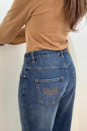 Elisha Baggy Jean Indigo by Sneaky Link, relaxed mid-rise baggy jeans in 100% cotton with branded details. Runs big; size down if unsure.