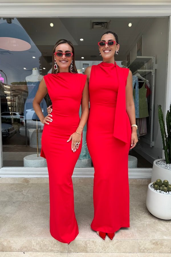 Audrey Gown Cherry Red by Effie Kats – A chic stretch crepe gown with a straight neckline, exaggerated low back, and elegant over-the-shoulder detail, perfect for special occasions.